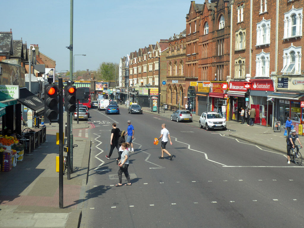 London Road in Norbury, with shops, buses and traffic on the A23